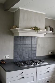 a stove top oven sitting inside of a kitchen