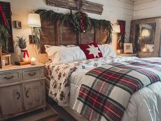 a bedroom decorated for christmas with plaid blankets and lights on the headboard, dressers and bed