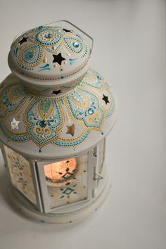 a white and blue lit up lantern with stars on it