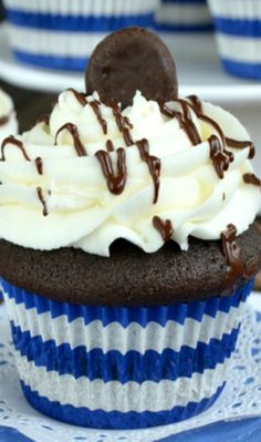 a chocolate cupcake with white frosting and an oreo on top