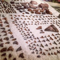 several different types of rocks and stones laid out on a table with one rock in the middle