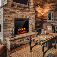 a living room filled with furniture and a fire place in front of a flat screen tv