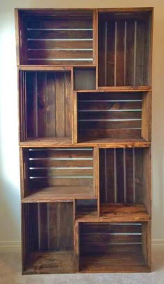 a wooden shelf with several shelves on top of it and some drawers in the middle