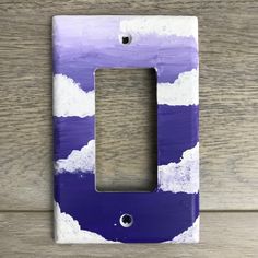 a purple and white painted light switch plate