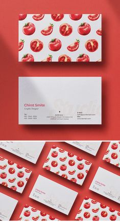 the business card has tomatoes on it and is next to some red cards with white envelopes