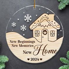 a wooden ornament with a house and snowflakes hanging from it's side