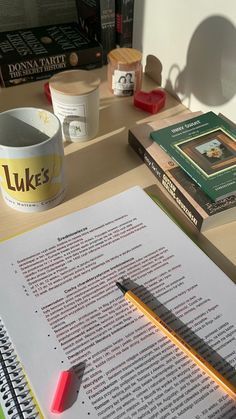 an open book on a desk with a pencil