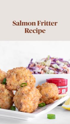 some fried food on a white plate next to coleslaw and lemon wedges