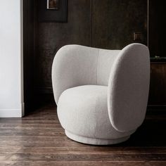 a white chair sitting on top of a wooden floor