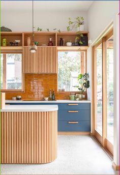 an image of a kitchen setting with wooden cabinets and blue counter tops in the middle