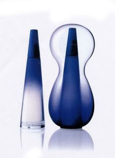 two blue vases sitting next to each other on a white surface with reflections in it