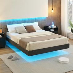 a bed that has some lights on the headboard and foot board in front of it