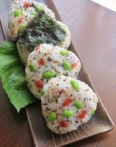 rice balls with vegetables and sauce on a plate