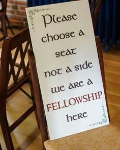 a sign on a chair that says please choose a seat not a side we are a fellowship here