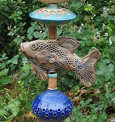 two fish on top of each other in a garden