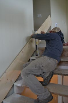 a man climbing up the side of a stair case