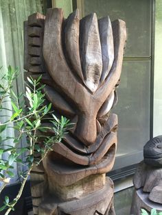 a wooden sculpture sitting next to a window