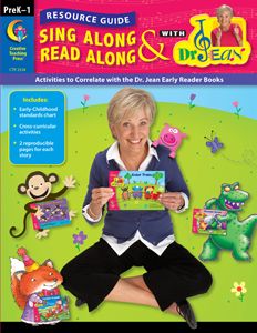 an older woman sitting on the ground holding up a book with other children's books