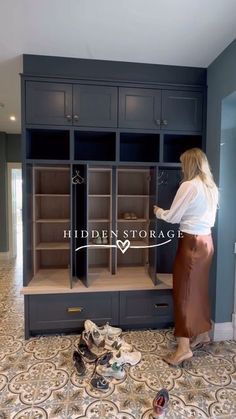 a woman standing in front of a cabinet with shoes on the floor