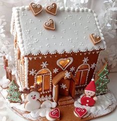 a gingerbread house decorated with icing and decorations