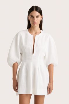 A vacation-style mini dress with a low split at the neckline and oversized rounded sleeves that reach down to the elbow. Imagined in White 100% European Flax® linen, it cinches in at the waist before falling into a soft A-line skirt with pleat details. A shorter iteration of the Soleil Maxi Dress, wear on warm summer days with simple accessories. Mini Dress White, Maxi Dress Sale, Mini Dresses Online, Faithfull The Brand, Spring Wardrobe, White Maxi Dresses, Event Dresses, White Mini Dress, Dress White