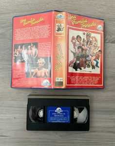 an old vhs case with the back cover open and two discs in front of it