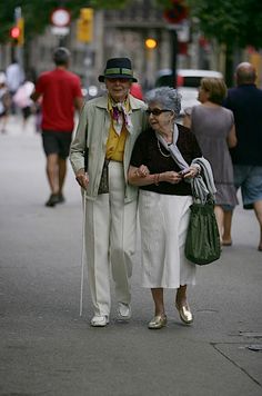 an older couple walking down the street together