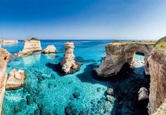 the water is crystal blue and there are some rocks sticking out of it's sides