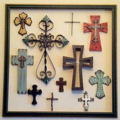 a cross is hanging on the wall with other crosses