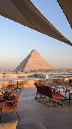 an outdoor dining area in front of the pyramids