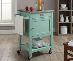 a kitchen cart with an open drawer on wheels