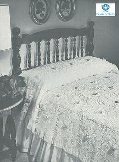 an old black and white photo of a bed