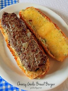 two pieces of bread sitting on top of a white plate next to another piece of meat