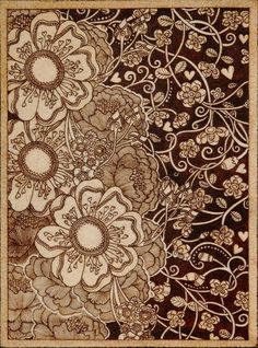 an intricately designed rug with flowers and hearts on the bottom, in brown tones