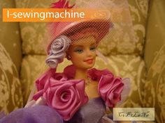 a barbie doll wearing a pink hat and dress with flowers on it's head