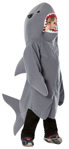 a young boy in a shark costume