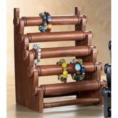 a wooden rack with bracelets on it