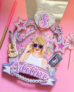 a pink table topped with an assortment of items and a sticker that says,'8 adelinne '