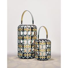 two handbags made out of metal and wood with geometric designs on the sides, one is