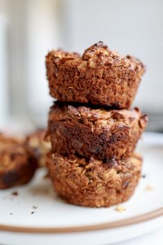 three muffins stacked on top of each other on a white and brown plate