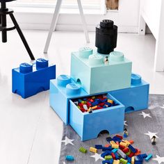 two legos are sitting on the floor next to each other and one is filled with blocks