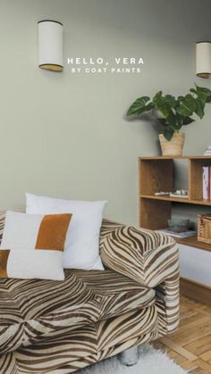 a living room with zebra print couch and bookshelf on the wall above it