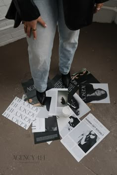 a person standing on the ground surrounded by papers