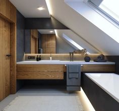 an attic bathroom with skylight and large bathtub