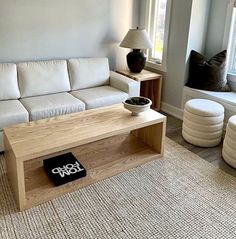 a living room with a white couch and wooden coffee table