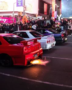 several cars are parked on the street as people watch