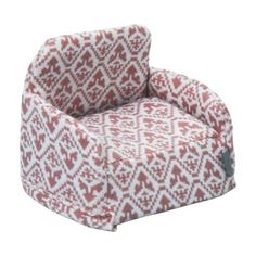 a red and white chair with a pattern on it's back end, sitting in front of a white background