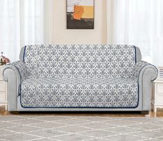 a blue and white couch sitting in a living room