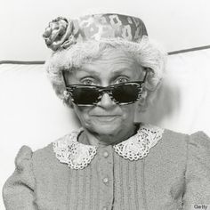 an old woman wearing sunglasses and a hat with the quote, cherub statutes will protect you better than a burgular alarm