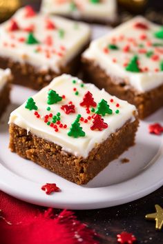 several pieces of cake on a plate with white frosting and red and green sprinkles